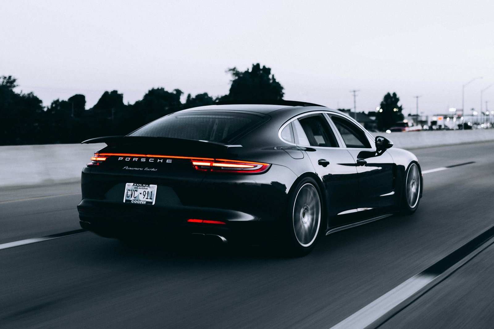 Glossy black sports sedan on the road